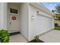 Inviting front entrance featuring a decorative wreath on the door and well-maintained landscaping at 630 Lake Cypress Cir, Oldsmar, FL 34677