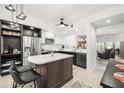 Stylish kitchen with stainless steel appliances, a center island, modern cabinetry, and updated countertops at 6330 99Th N Way # 14B, Seminole, FL 33708