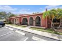 Inviting villa showcasing an arched entry, lush lawn, and convenient parking at 6346 Bonnie Bay N Cir, Pinellas Park, FL 33781