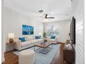 Bright living room featuring a modern ceiling fan, plush seating, and stylish decor at 6706 47Th N St, Pinellas Park, FL 33781