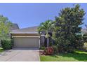 Charming single-Gathering home featuring a landscaped front yard and covered entry at 6932 Old Benton Dr, Apollo Beach, FL 33572