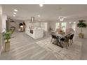 Spacious open-concept kitchen with a large island, stainless steel hood, and light gray flooring at 939 Woodland Dr, Palm Harbor, FL 34683