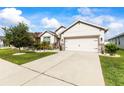 Charming home with a two-car garage, manicured lawn, and tastefully landscaped front yard at 944 Old Windsor Way, Spring Hill, FL 34609