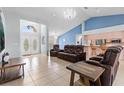 Open-concept living room featuring tile flooring, high ceilings, and stylish furniture at 10446 Baylor Dr, Spring Hill, FL 34608