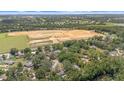 Expansive aerial view of a new construction site surrounded by lush greenery and established neighborhoods at 12412 Lakeview Dr, Dade City, FL 33525