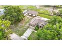 Aerial shot showcasing home's layout, driveway, outbuilding, and surrounding wooded acreage at 1332 Osceola Hollow Rd, Odessa, FL 33556