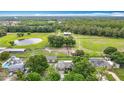 Expansive aerial view of horse property with pond, paddocks, outbuildings, and lush surrounding landscape at 1332 Osceola Hollow Rd, Odessa, FL 33556