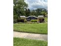 Beautiful Lake Tiffany community sign surrounded by manicured landscaping and lush green lawns in a well-maintained setting at 1408 Millstream Ln # 206, Dunedin, FL 34698