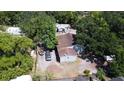 An aerial view of the home showing mature trees and ample parking at 14210 Downing St, Dover, FL 33527