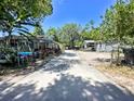 A sunny exterior view of a home highlighting the driveway and front of house at 14210 Downing St, Dover, FL 33527