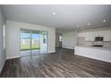 Spacious living room featuring modern flooring, access to the backyard, and an open layout at 14411 Meadow Bird Ave, Riverview, FL 33579