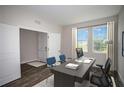 Bright office space with a large desk, two windows, and a view of the neighborhood at 14411 Meadow Bird Ave, Riverview, FL 33579