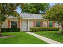 Lovely single-story home with a well-kept lawn and walkway leading to the front door, framed by lush landscaping at 1535 Nursery Rd # 110, Clearwater, FL 33756
