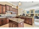 Well-equipped kitchen with granite countertops, wood cabinets, and stainless steel appliances at 16248 Ivy Lake Dr, Odessa, FL 33556