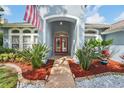 Inviting front entrance with a red double door and lush landscaping welcomes you home at 18712 Forest Glen Ct, Tampa, FL 33647