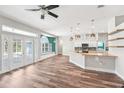 Open-concept living space boasts wood floors, plenty of natural light, and a seamless flow to the modern kitchen at 18712 Forest Glen Ct, Tampa, FL 33647