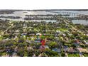 Aerial view of a neighborhood showcasing waterfront homes and lush greenery, with a red pin highlighting the property at 208 Live Oak Ln, Largo, FL 33770