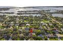 Breathtaking aerial view of a waterfront community showcasing lush greenery and the beautiful home's location near the bay at 208 Live Oak Ln, Largo, FL 33770
