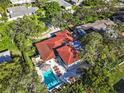Aerial view of a home featuring a private pool, patio area, and well-maintained landscaping at 208 Live Oak Ln, Largo, FL 33770