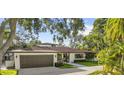Beautiful one-story home with an attached garage, landscaped front yard, and inviting curb appeal at 208 Live Oak Ln, Largo, FL 33770