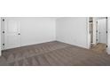 A bedroom featuring neutral carpeting and a walk-in closet at 29563 Fedora Cir, Brooksville, FL 34602