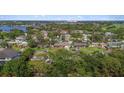 An aerial view of a residential neighborhood, featuring lush greenery and scenic water views in the distance at 3235 Walnut Ne St, St Petersburg, FL 33704