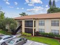 Exterior shot of this two story building with manicured landscaping and covered balcony at 3389 Crystal E Ct # J, Palm Harbor, FL 34685