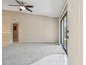 Bright living room with carpet and tile, sliding glass door with view, and white front door at 3389 Crystal E Ct # J, Palm Harbor, FL 34685