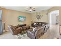 Comfortable living room with tile floors, neutral colors, and ample seating space at 34447 Windknob Ct, Wesley Chapel, FL 33545