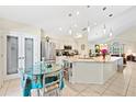 Bright, airy kitchen features a large island, pendant lighting, and a pantry at 4047 Eagle Cove West Dr, Palm Harbor, FL 34685