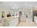 Open concept kitchen features a large island, granite countertops and stainless steel appliances at 4047 Eagle Cove West Dr, Palm Harbor, FL 34685