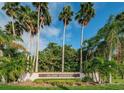 Island Estates community sign surrounded by lush tropical landscaping and palm trees at 431 Windward Psge, Clearwater Beach, FL 33767