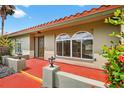 Charming home featuring large arched windows and a red-tiled roof, blending character with curb appeal at 431 Windward Psge, Clearwater Beach, FL 33767