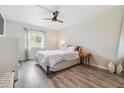 The bedroom features hardwood floors, a ceiling fan, and plenty of natural light at 4513 S Oak Dr # Q21, Tampa, FL 33611