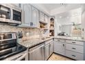 The kitchen boasts granite countertops, stainless steel appliances and elegant white cabinets at 4513 S Oak Dr # Q21, Tampa, FL 33611