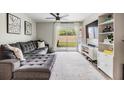 Relax in the living room with plush gray sectional sofa and sliding glass doors to the backyard at 4513 S Oak Dr # Q21, Tampa, FL 33611