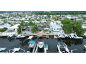 Aerial view of a waterfront community showing multiple docks and boats along a canal with stunning residential homes at 4931 Pelican Dr, New Port Richey, FL 34652