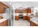 Spacious kitchen with stainless steel appliances, marble counter tops, and abundant wooden cabinetry at 5013 119Th E Ter, Parrish, FL 34219