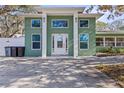 The home features a grand entrance with an inviting front door and stylish architectural accents at 5657 Oceanic Rd, Holiday, FL 34690