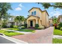 Inviting two-story home featuring a brick driveway leading up to a covered front porch at 6113 Yeats Manor Dr, Tampa, FL 33616