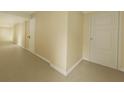 Clean hallway with carpet, white trim, and multiple white doors, offering a minimalist aesthetic at 650 Island Way # 408, Clearwater Beach, FL 33767