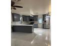 A stylish kitchen boasts sleek gray cabinets, marble countertops, and stainless steel appliances at 6820 26Th W St, Bradenton, FL 34207