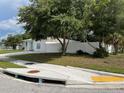 Single-story home surrounded by mature trees and a white fence at 7536 38Th N Ave, St Petersburg, FL 33710