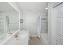 Well-lit bathroom with white tiled shower, modern sink and vanity, neutral walls, and a clean, functional layout at 7547 Landmark Dr, Spring Hill, FL 34606