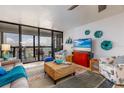 Bright living room with a cozy seating area and a sliding glass door to the balcony at 9525 Blind Pass Rd # 505, St Pete Beach, FL 33706