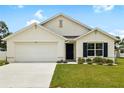 Charming single-story home featuring a two-car garage and manicured front lawn at 10452 Elgin Blvd, Spring Hill, FL 34608