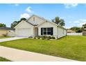 Charming single-story home featuring a two-car garage and a lush green lawn at 10452 Elgin Blvd, Spring Hill, FL 34608