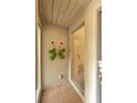 Covered front patio with tile flooring and wall decor providing a cozy entrance at 1111 N Bayshore Blvd # E10, Clearwater, FL 33759