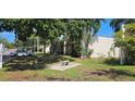 Exterior of building with inviting bench seating area under mature shade trees at 11511 113Th St # 4F, Seminole, FL 33778