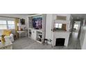Inviting living room with a fireplace, custom shelving, and bright, sunny windows at 123 S Dolphin Dr, Oldsmar, FL 34677